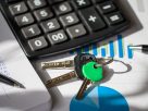 Calculator, keys, and financial documents on a desk